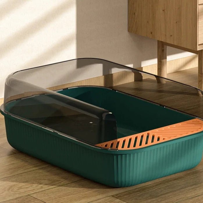 Bac à litière pour chat design moderne, vert et orange, avec couvercle et pelle.