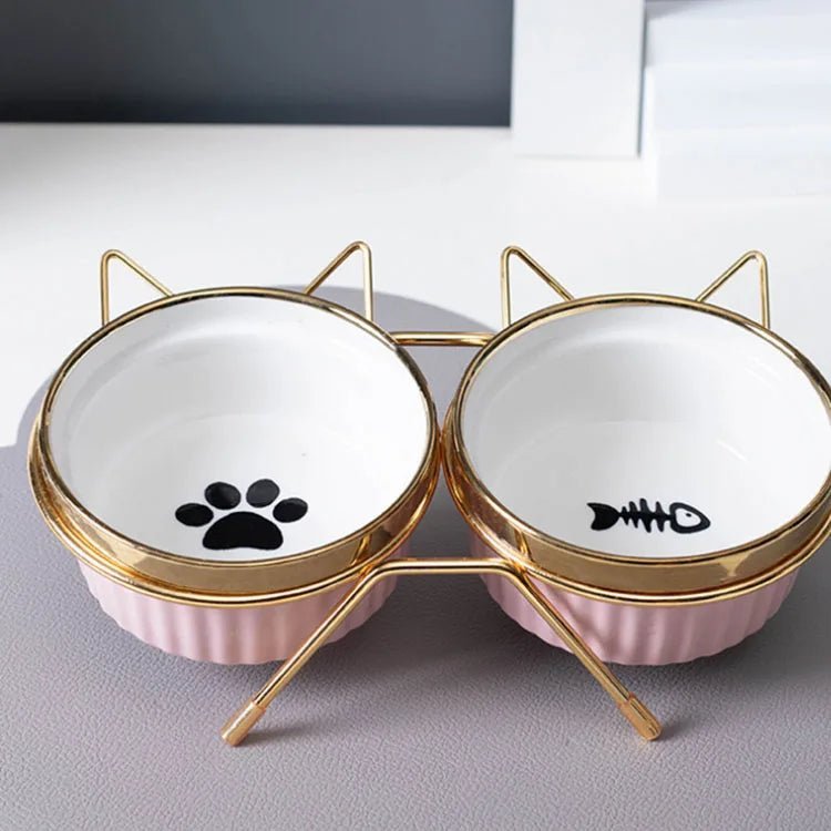 Gamelle rose inclinée double pour chat avec support antidérapant, design ergonomique et matériau plastique durable.