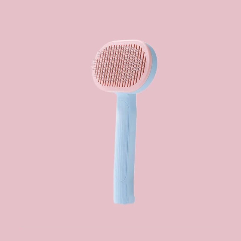 Brosse auto-nettoyante pour chat coloris bleu et rose, avec poils en acier inoxydable et bouton poussoir