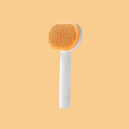 Brosse de toilettage orange pour chat, système auto-nettoyant et poignée ergonomique